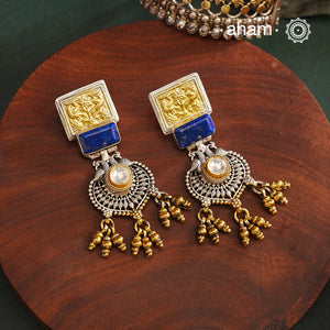 Noori Two Tone Peacock Silver Earrings. The earrings are handcrafted in 92.5 sterling silver with gold highlights.Style this up with your favourite ethnic or fusion outfits to complete the look.