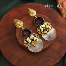 Elevate your look with Noori Two Tone Silver Earrings. Expertly handcrafted in 92.5 silver with gold tone highlights, these earrings feature a stunning black onyx ring in the center, is  beautiful flower surrounded by intricate peacocks on each sides. Perfect for adding a touch of contemporary elegance to any ensemble.