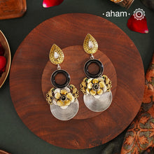 Elevate your look with Noori Two Tone Silver Earrings. Expertly handcrafted in 92.5 silver with gold tone highlights, these earrings feature a stunning black onyx ring in the center, is  beautiful flower surrounded by intricate peacocks on each sides. Perfect for adding a touch of contemporary elegance to any ensemble.