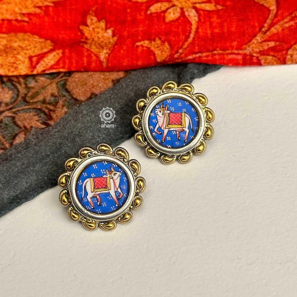 Handpainted Nandi studs in pichwai style set in 92.5 silver with dual tones.Style this up with your favourite ethnic or fusion outfits to complete the look.