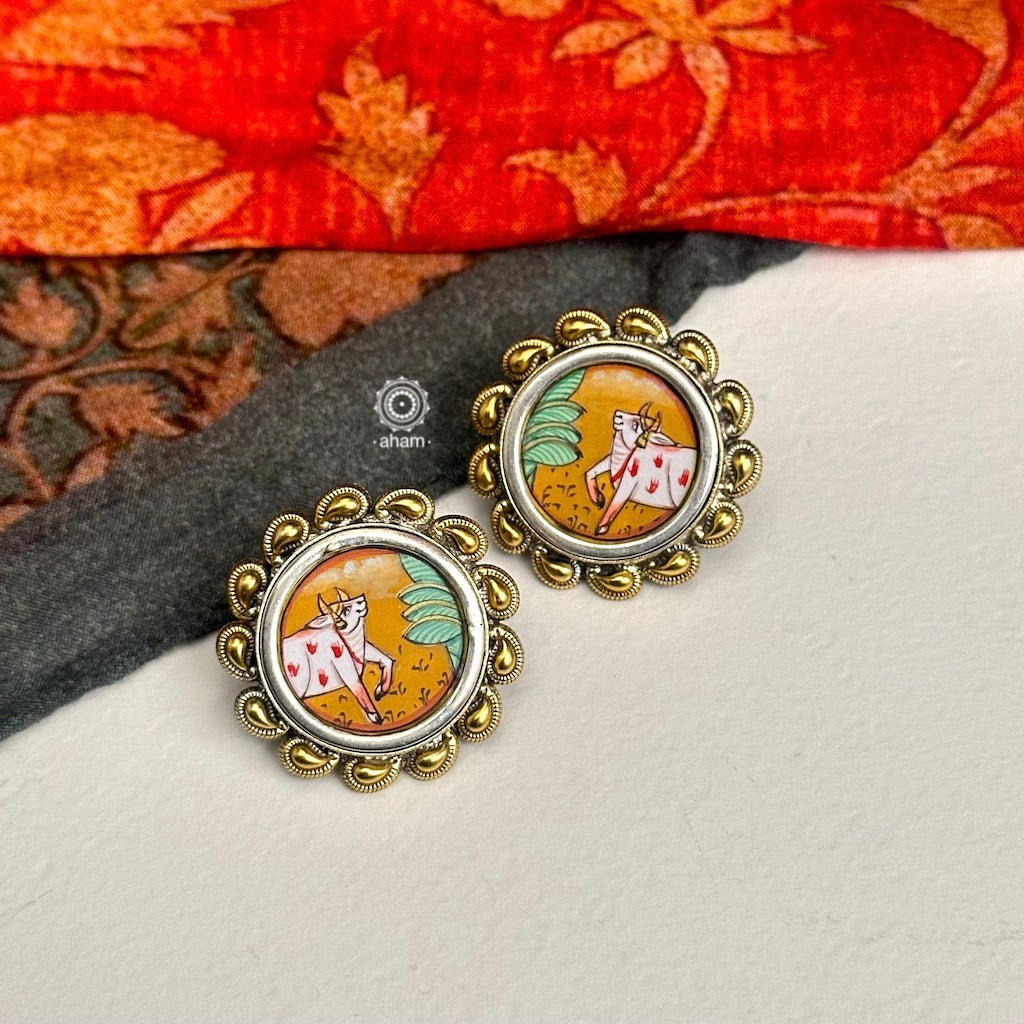 Handpainted Nandi studs in pichwai style set in 92.5 silver with dual tones. Style this up with your favourite ethnic or fusion outfits to complete the look.