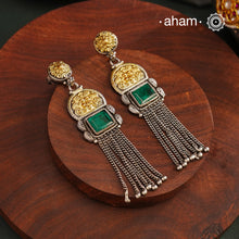 Elevate your style with our Noori Two Tone Silver Earrings. These beautiful long danglers feature a stunning faux emerald in the center, surrounded by gold highlights. Crafted in 92.5 silver, they offer a modern twist on traditional jewelry. Enhance your look with these elegant statement pieces.