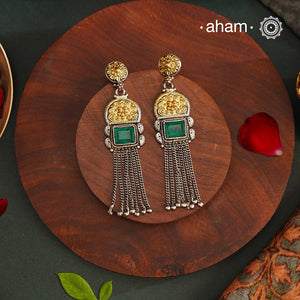 Elevate your style with our Noori Two Tone Silver Earrings. These beautiful long danglers feature a stunning faux emerald in the center, surrounded by gold highlights. Crafted in 92.5 silver, they offer a modern twist on traditional jewelry. Enhance your look with these elegant statement pieces.