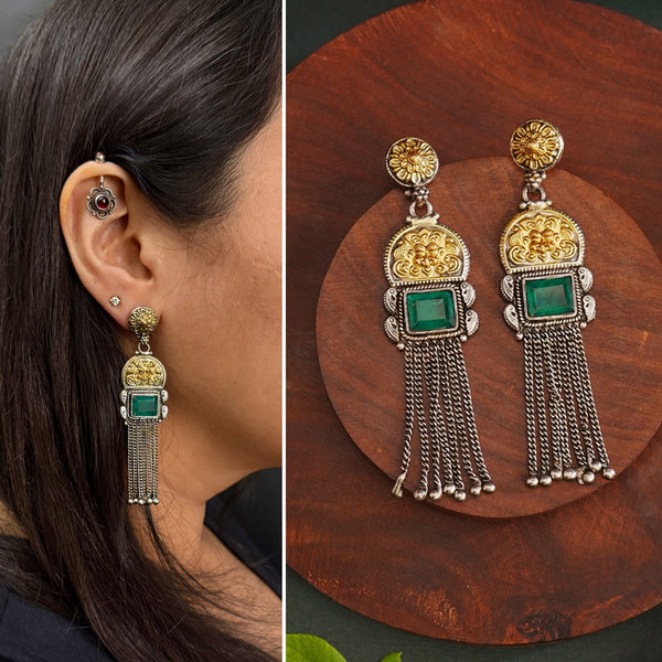 Elevate your style with our Noori Two Tone Silver Earrings. These beautiful long danglers feature a stunning faux emerald in the center, surrounded by gold highlights. Crafted in 92.5 silver, they offer a modern twist on traditional jewelry. Enhance your look with these elegant statement pieces.