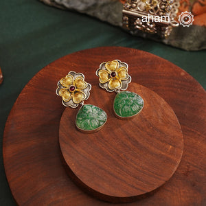 Perfect Two tone flower drop earrings with carved green stone drop. The earrings are handcrafted in 92.5 sterling silver with gold highlights. Style this up with your favourite ethnic or fusion outfits to complete the look.