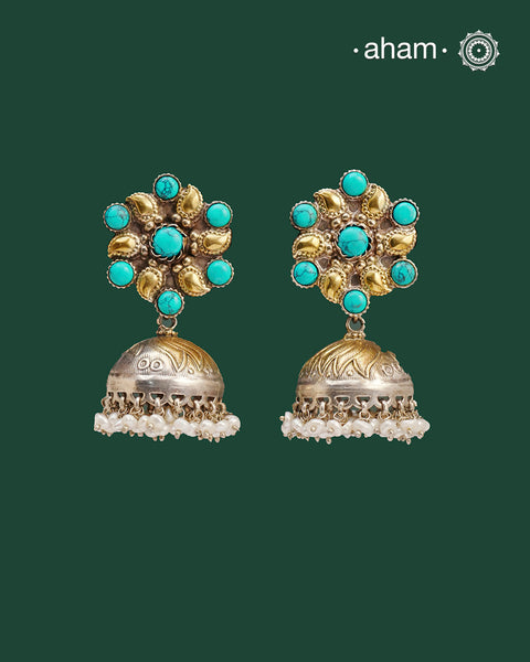 Noori two tone Jhumkie. The earrings are handcrafted in 92.5 sterling silver with gold tones and turquoise highlights. Style this up with your favourite ethnic or fusion outfits to complete the look.