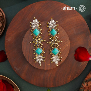 Noori two tone Earrings. The earrings are handcrafted in 92.5 sterling silver with gold highlights and blue stone setting. Long yet lightweight, perfect to style this up with your favourite ethnic or fusion outfits to complete the look..