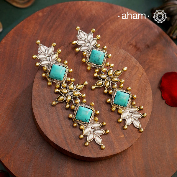 Noori two tone Earrings. The earrings are handcrafted in 92.5 sterling silver with gold highlights and blue stone setting. Long yet lightweight, perfect to style this up with your favourite ethnic or fusion outfits to complete the look..