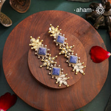 Noori two tone Earrings. The earrings are handcrafted in 92.5 sterling silver with gold highlights and blue stone setting. Long yet lightweight, perfect to style this up with your favourite ethnic or fusion outfits to complete the look.