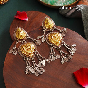 Enhance your style with the timeless elegance of the Dual Tone Silver Earrings. Handcrafted by skilled karigars in Barmer, Rajasthan, this earring features traditional Bandhel work, where a thin sheet of hand beaten 22 carat gold is set on 92.5 silver using a unique wax filling technique. A classic representation of Indian craftsmanship.