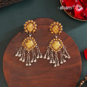 Enhance your style with the timeless elegance of the Dual Tone Silver Earrings. Handcrafted by skilled karigars in Barmer, Rajasthan, this earring features traditional Bandhel work, where a thin sheet of hand beaten 22 carat gold is set on 92.5 silver using a unique wax setting technique. A classic representation of Indian craftsmanship.