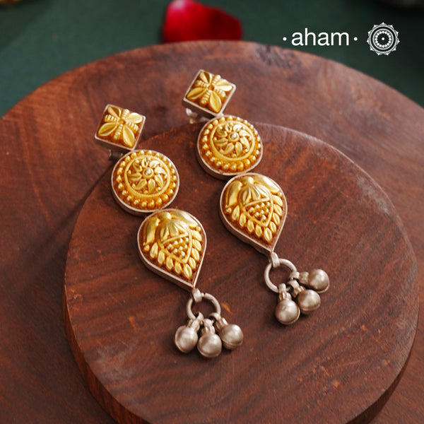 Enhance your style with the timeless elegance of the Dual Tone Silver Earrings. Handcrafted by skilled karigars in Barmer, Rajasthan, this earring features traditional Bandhel work, where a thin sheet of hand beaten 22 carat gold is set on 92.5 silver using a unique wax filling technique. A classic representation of Indian craftsmanship.