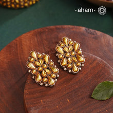 Enhance your style with the timeless elegance of the Dual Tone Silver Earrings. Handcrafted by skilled karigars in Barmer, Rajasthan, this earring features traditional Bandhel work, where a thin sheet of hand beaten 22 carat gold is set on 92.5 silver using a unique wax filling technique. A classic representation of Indian craftsmanship.