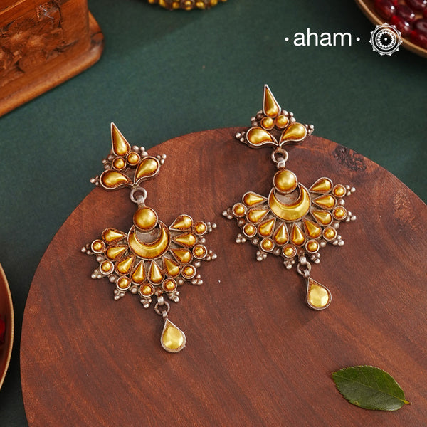 Enhance your style with the timeless elegance of the Dual Tone Silver Earrings. Handcrafted by skilled karigars in Barmer, Rajasthan, this earring features traditional Bandhel work, where a thin sheet of hand beaten 22 carat gold is set on 92.5 silver using a unique wax filling technique. A classic representation of Indian craftsmanship.