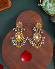 Enhance your style with the timeless elegance of the Dual Tone Silver Earrings. Handcrafted by skilled karigars in Barmer, Rajasthan, this earring features traditional Bandhel work, where a thin sheet of hand beaten 22 carat gold is set on 92.5 silver using a unique wax filling technique. A classic representation of Indian craftsmanship.