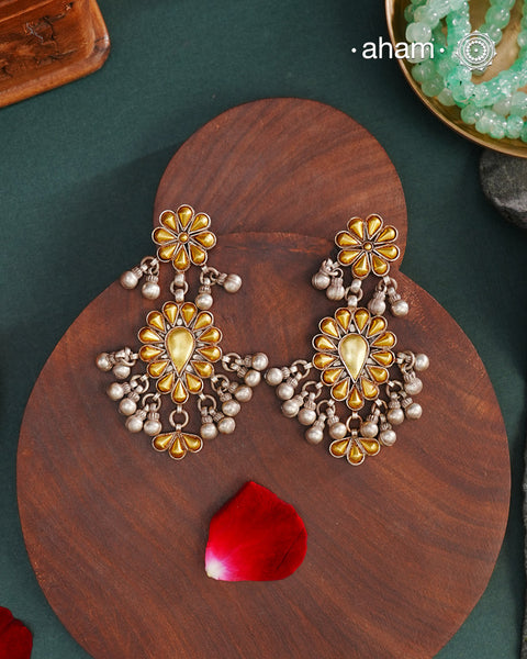 Enhance your style with the timeless elegance of the Dual Tone Silver Earrings. Handcrafted by skilled karigars in Barmer, Rajasthan, this earring features traditional Bandhel work, where a thin sheet of hand beaten 22 carat gold is set on 92.5 silver using a unique wax filling technique. A classic representation of Indian craftsmanship.