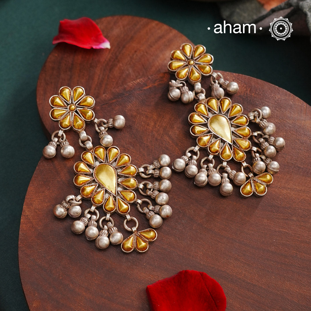 Enhance your style with the timeless elegance of the Dual Tone Silver Earrings. Handcrafted by skilled karigars in Barmer, Rajasthan, this earring features traditional Bandhel work, where a thin sheet of hand beaten 22 carat gold is set on 92.5 silver using a unique wax filling technique. A classic representation of Indian craftsmanship.