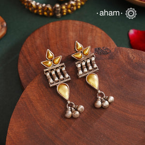 Enhance your style with the timeless elegance of the Dual Tone Silver Earrings. Handcrafted by skilled karigars in Barmer, Rajasthan, this earring features traditional Bandhel work, where a thin sheet of hand beaten 22 carat gold is set on 92.5 silver using a unique wax filling technique. A classic representation of Indian craftsmanship.