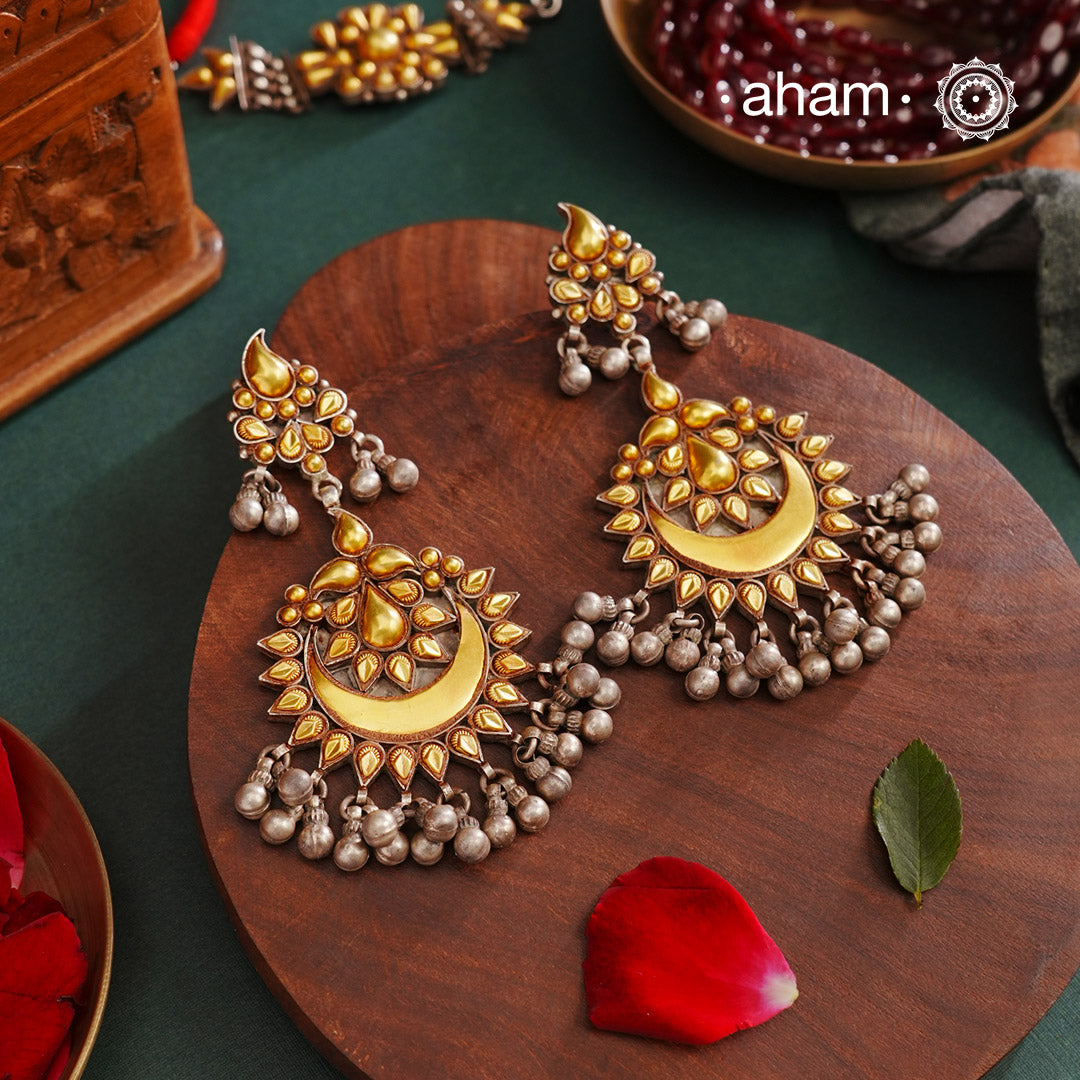 Enhance your style with the timeless elegance of the Dual Tone Silver Earrings. Handcrafted by skilled karigars in Barmer, Rajasthan, this earring features traditional Bandhel work, where a thin sheet of hand beaten 22 carat gold is set on 92.5 silver using a unique wax filling technique. A classic representation of Indian craftsmanship.