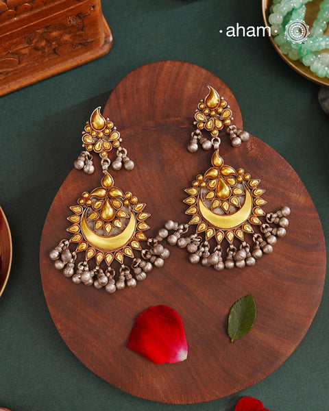 Enhance your style with the timeless elegance of the Dual Tone Silver Earrings. Handcrafted by skilled karigars in Barmer, Rajasthan, this earring features traditional Bandhel work, where a thin sheet of hand beaten 22 carat gold is set on 92.5 silver using a unique wax filling technique. A classic representation of Indian craftsmanship.