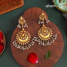 Enhance your style with the timeless elegance of the Dual Tone Silver Earrings. Handcrafted by skilled karigars in Barmer, Rajasthan, this earring features traditional Bandhel work, where a thin sheet of hand beaten 22 carat gold is set on 92.5 silver using a unique wax filling technique. A classic representation of Indian craftsmanship.