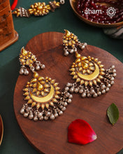 Enhance your style with the timeless elegance of the Dual Tone Silver Earrings. Handcrafted by skilled karigars in Barmer, Rajasthan, this earring features traditional Bandhel work, where a thin sheet of hand beaten 22 carat gold is set on 92.5 silver using a unique wax filling technique. A classic representation of Indian craftsmanship.