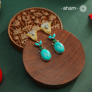 Noori two tone Earrings. The earrings are handcrafted in 92.5 sterling silver with turquoise stone and gold highlights. Style this up with your favourite ethnic or indo western outfits to complete the look.