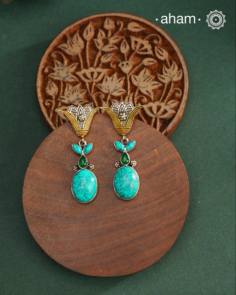 Noori two tone Earrings. The earrings are handcrafted in 92.5 sterling silver with turquoise stone and gold highlights. Style this up with your favourite ethnic or indo western outfits to complete the look.