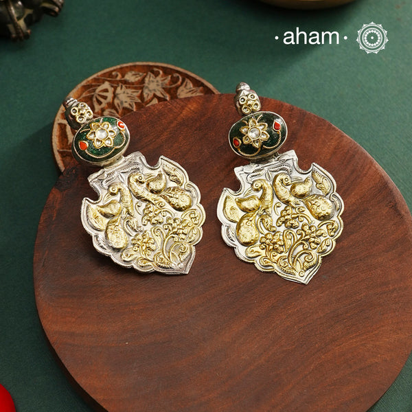 Enhance your look with our Noori Two Tone Silver Earrings! These elegant earrings feature a beautiful inlay work stone highlight with elegant peacock motifs. Crafted in 92.5 silver.