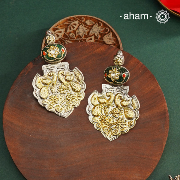 Enhance your look with our Noori Two Tone Silver Earrings! These elegant earrings feature a beautiful inlay work stone highlight with elegant peacock motifs. Crafted in 92.5 silver.
