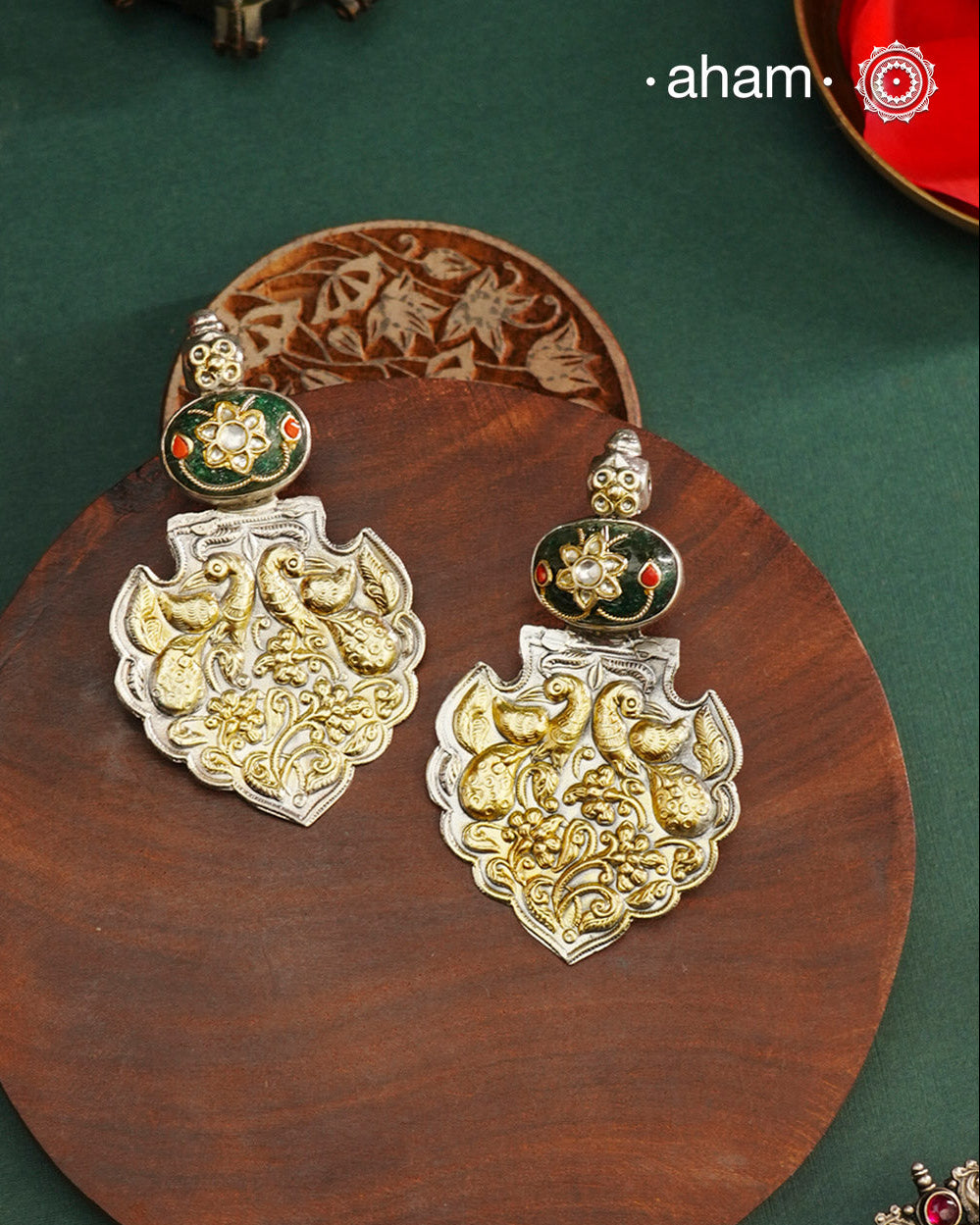 Enhance your look with our Noori Two Tone Silver Earrings! These elegant earrings feature a beautiful inlay work stone highlight with elegant peacock motifs. Crafted in 92.5 silver.