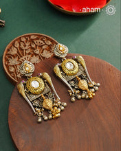 Noori dual tone parrot Earrings. The earrings are handcrafted in 92.5 sterling silver with kudan, pearl and&nbsp; gold highlights. Style this up with your favourite ethnic or fusion outfits to complete the look.