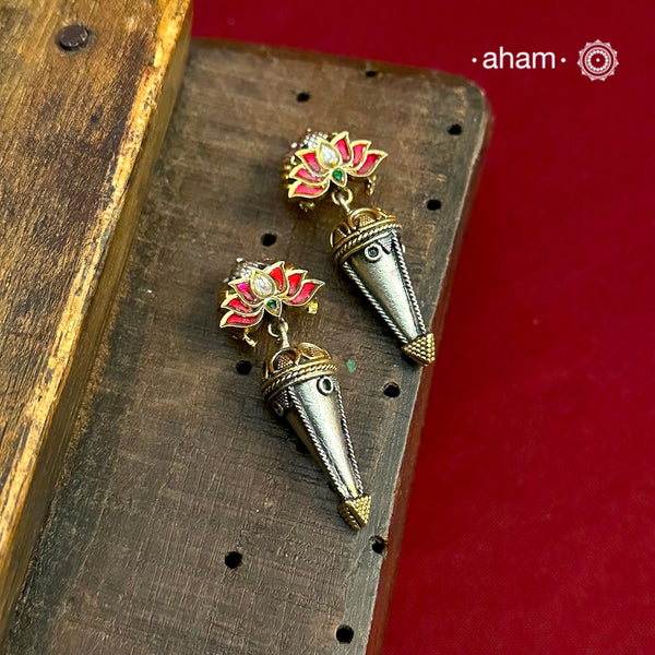 Crafted with delicate 92.5 silver, these stunning Noori Two Tone Lotus Earrings feature a vibrant green stone drop, adding a touch of elegance to any outfit. The intricate Lotus design showcases expert craftsmanship and is perfect for a sophisticated and stylish look.