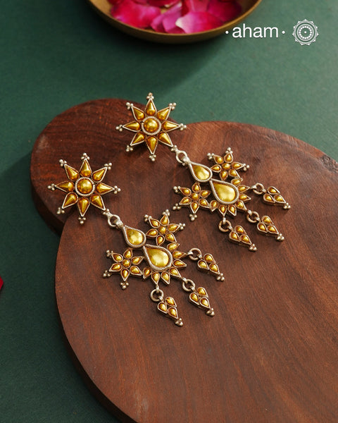 Enhance your style with the timeless elegance of the Dual Tone Silver Earrings. Handcrafted by skilled karigars in Barmer, Rajasthan, this earring features traditional Bandhel work, where a thin sheet of hand beaten 22 carat gold is fused with 92.5 silver and then set on 92.5 silver using a unique wax filling technique. A classic representation of Indian craftsmanship.