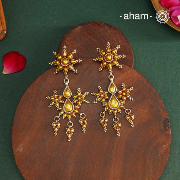 Enhance your style with the timeless elegance of the Dual Tone Silver Earrings. Handcrafted by skilled karigars in Barmer, Rajasthan, this earring features traditional Bandhel work, where a thin sheet of hand beaten 22 carat gold is fused with 92.5 silver and then set on 92.5 silver using a unique wax filling technique. A classic representation of Indian craftsmanship.