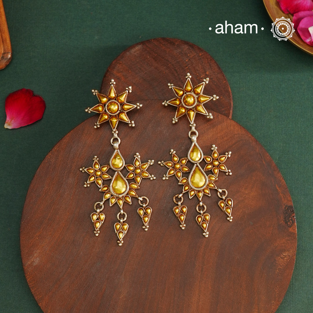 Enhance your style with the timeless elegance of the Dual Tone Silver Earrings. Handcrafted by skilled karigars in Barmer, Rajasthan, this earring features traditional Bandhel work, where a thin sheet of hand beaten 22 carat gold is fused with 92.5 silver and then set on 92.5 silver using a unique wax filling technique. A classic representation of Indian craftsmanship.