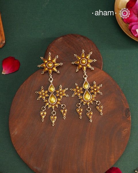 Enhance your style with the timeless elegance of the Dual Tone Silver Earrings. Handcrafted by skilled karigars in Barmer, Rajasthan, this earring features traditional Bandhel work, where a thin sheet of hand beaten 22 carat gold is fused with 92.5 silver and then set on 92.5 silver using a unique wax filling technique. A classic representation of Indian craftsmanship.