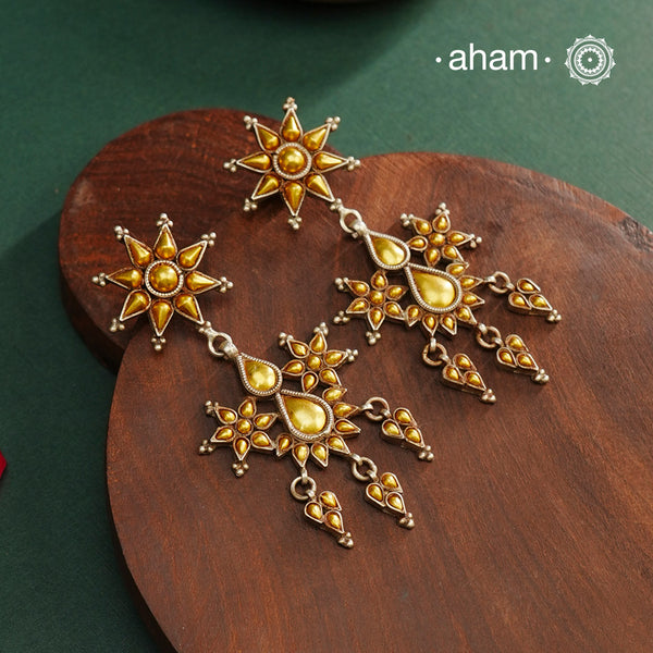 Enhance your style with the timeless elegance of the Dual Tone Silver Earrings. Handcrafted by skilled karigars in Barmer, Rajasthan, this earring features traditional Bandhel work, where a thin sheet of hand beaten 22 carat gold is fused with 92.5 silver and then set on 92.5 silver using a unique wax filling technique. A classic representation of Indian craftsmanship.