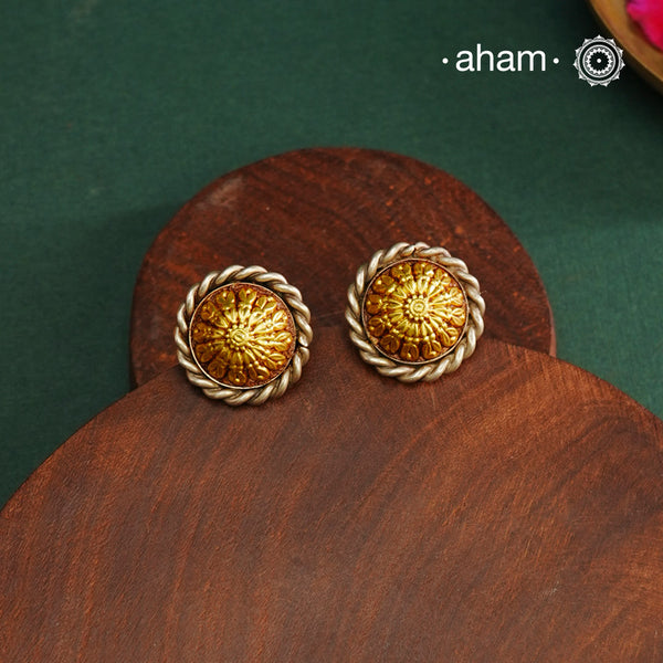 Enhance your style with the timeless elegance of the Dual Tone Silver Earrings. Handcrafted by skilled karigars in Barmer, Rajasthan, this earring features traditional Bandhel work, where a thin sheet of hand beaten 22 carat gold is set on 92.5 silver using a unique wax filling technique. A classic representation of Indian craftsmanship.
