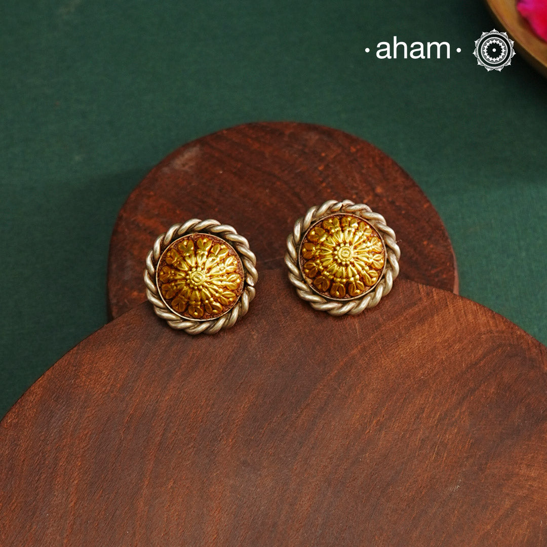 Enhance your style with the timeless elegance of the Dual Tone Silver Earrings. Handcrafted by skilled karigars in Barmer, Rajasthan, this earring features traditional Bandhel work, where a thin sheet of hand beaten 22 carat gold is set on 92.5 silver using a unique wax filling technique. A classic representation of Indian craftsmanship.