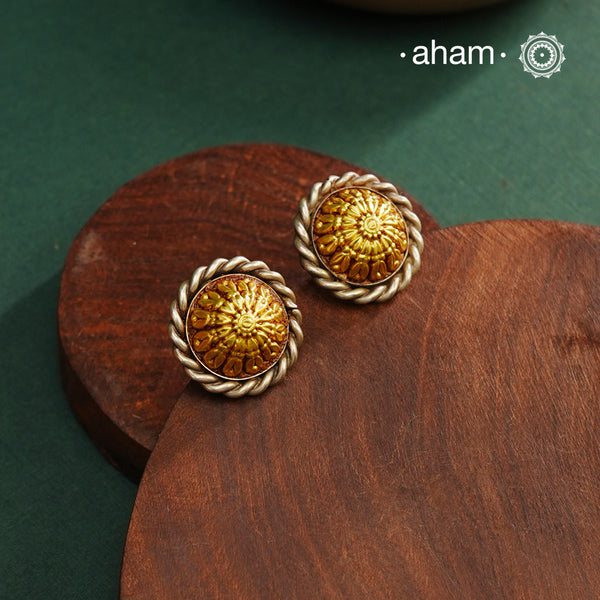 Enhance your style with the timeless elegance of the Dual Tone Silver Earrings. Handcrafted by skilled karigars in Barmer, Rajasthan, this earring features traditional Bandhel work, where a thin sheet of hand beaten 22 carat gold is set on 92.5 silver using a unique wax filling technique. A classic representation of Indian craftsmanship.