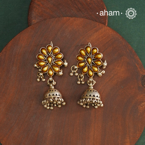 Enhance your style with the timeless elegance of the Dual Tone Silver Earrings. Handcrafted by skilled karigars in Barmer, Rajasthan, this earring features traditional Bandhel work, where a thin sheet of hand beaten 22 carat gold is fused with 92.5 silver and then set on 92.5 silver using a unique wax filling technique. A classic representation of Indian craftsmanship.