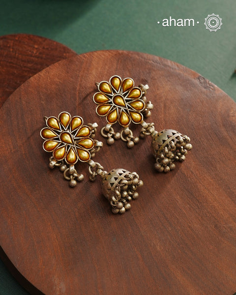 Enhance your style with the timeless elegance of the Dual Tone Silver Earrings. Handcrafted by skilled karigars in Barmer, Rajasthan, this earring features traditional Bandhel work, where a thin sheet of hand beaten 22 carat gold is fused with 92.5 silver and then set on 92.5 silver using a unique wax filling technique. A classic representation of Indian craftsmanship.