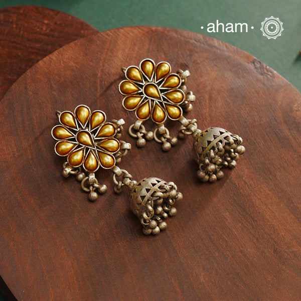 Enhance your style with the timeless elegance of the Dual Tone Silver Earrings. Handcrafted by skilled karigars in Barmer, Rajasthan, this earring features traditional Bandhel work, where a thin sheet of hand beaten 22 carat gold is fused with 92.5 silver and then set on 92.5 silver using a unique wax filling technique. A classic representation of Indian craftsmanship.