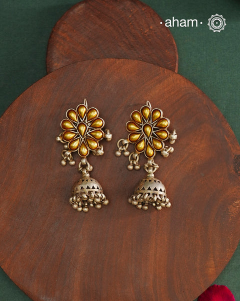 Enhance your style with the timeless elegance of the Dual Tone Silver Earrings. Handcrafted by skilled karigars in Barmer, Rajasthan, this earring features traditional Bandhel work, where a thin sheet of hand beaten 22 carat gold is fused with 92.5 silver and then set on 92.5 silver using a unique wax filling technique. A classic representation of Indian craftsmanship.