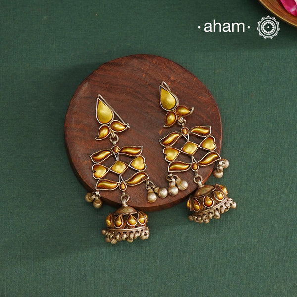 Enhance your style with the timeless elegance of the Dual Tone Silver Earrings. Handcrafted by skilled karigars in Barmer, Rajasthan, this earring features traditional Bandhel work, where a thin sheet of hand beaten 22 carat gold is fused with 92.5 silver and then set on 92.5 silver using a unique wax filling technique. A classic representation of Indian craftsmanship.