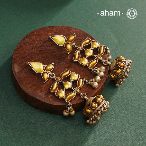 Enhance your style with the timeless elegance of the Dual Tone Silver Earrings. Handcrafted by skilled karigars in Barmer, Rajasthan, this earring features traditional Bandhel work, where a thin sheet of hand beaten 22 carat gold is fused with 92.5 silver and then set on 92.5 silver using a unique wax filling technique. A classic representation of Indian craftsmanship.
