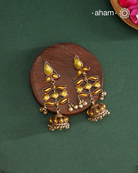 Enhance your style with the timeless elegance of the Dual Tone Silver Earrings. Handcrafted by skilled karigars in Barmer, Rajasthan, this earring features traditional Bandhel work, where a thin sheet of hand beaten 22 carat gold is fused with 92.5 silver and then set on 92.5 silver using a unique wax filling technique. A classic representation of Indian craftsmanship.