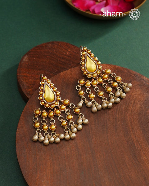Enhance your style with the timeless elegance of the Dual Tone Silver Earrings. Handcrafted by skilled karigars in Barmer, Rajasthan, this earring features traditional Bandhel work, where a thin sheet of hand beaten 22 carat gold is fused with 92.5 silver and then set on 92.5 silver using a unique wax filling technique. A classic representation of Indian craftsmanship.