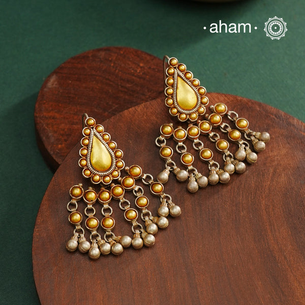 Enhance your style with the timeless elegance of the Dual Tone Silver Earrings. Handcrafted by skilled karigars in Barmer, Rajasthan, this earring features traditional Bandhel work, where a thin sheet of hand beaten 22 carat gold is fused with 92.5 silver and then set on 92.5 silver using a unique wax filling technique. A classic representation of Indian craftsmanship.